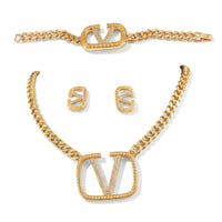 Gouden sieradenset met V-logo en kristallen, ketting, armband en oorbellen