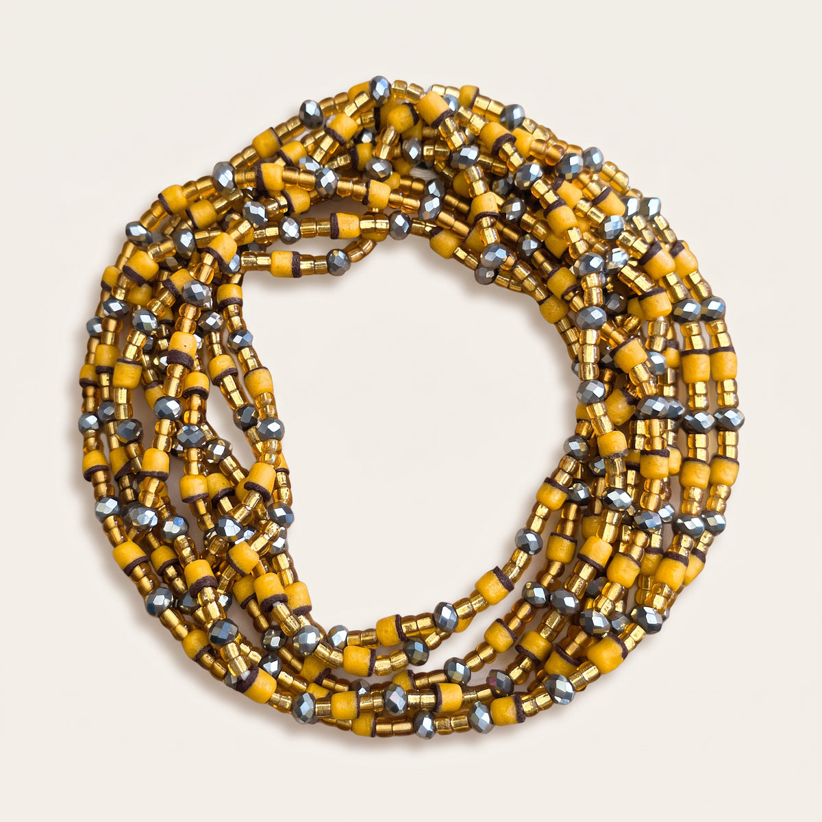 Okergele waistbeads met goudkleurige en grafietkleurige kralen